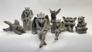 A small collection of gray stone gargoyle statues.