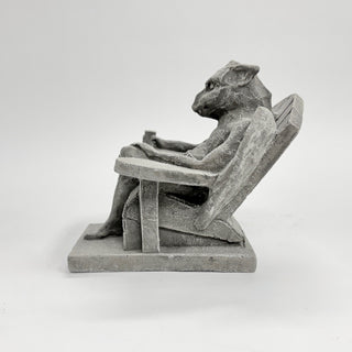 side view of a happy gargoyle, leaned back in an Adirondack chair with a drink in his hand on a white background. Laid back, relaxed, happy gargoyle House Parts home decor handmade Atlanta gargoyle grotesque whimsical fantasy mystical creature. Unique gift for fans of fantasy, dungeon, or dinosaurs. Unique Christmas gift for someone who has everything or fantasy lovers. Gothic, medieval, unique, artisan, craft, detail, specialty, a gift that no one else has, special