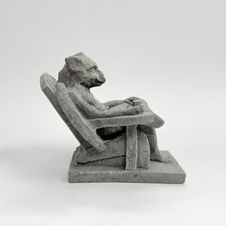 Opposite side view of a happy gargoyle, leaned back in an Adirondack chair with a drink in his hand on a white background. Laid back, relaxed, happy gargoyle House Parts home decor handmade Atlanta gargoyle grotesque whimsical fantasy mystical creature. Unique gift for fans of fantasy, dungeon, or dinosaurs. Unique Christmas gift for someone who has everything or fantasy lovers. Gothic, medieval, unique, artisan, craft, detail, specialty, a gift that no one else has, special