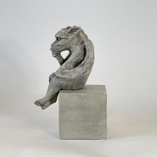 Side facing view of the baby seated gargoyle on a raised cement cube against a white background.

House Parts home decor handmade Atlanta gargoyle grotesque whimsical fantasy mystical creature. Unique gift for fans of fantasy, dungeon, or dinosaurs. Unique Christmas gift for someone who has everything or fantasy lovers. Gothic, medieval, unique, artisan, craft, detail, specialty, a gift that no one else has, special, protective