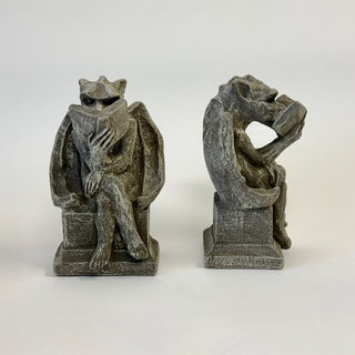 A pair of seated bookworm gargoyles bookends with legs crossed on a white background. one is facing forward and one is a side view

House Parts home decor handmade Atlanta gargoyle grotesque whimsical fantasy mystical creature. Unique gift for fans of fantasy, dungeon, or dinosaurs. Unique Christmas gift for someone who has everything or fantasy lovers. Gothic, medieval, unique, artisan, craft, detail, specialty, a gift that no one else has, special, protective
