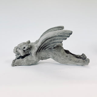 Another side view of a Gargoyle figurine has his hands and wings upward.  He can rest vertically or hang from the small loop that is built into him. The figurine is on a white background. House Parts home decor handmade Atlanta gargoyle grotesque whimsical fantasy mystical creature. Unique gift for fans of fantasy, dungeon, or dinosaurs. Unique Christmas gift for someone who has everything or fantasy lovers. Gothic, medieval, unique, artisan, craft, detail, specialty, a gift that no one else has, special