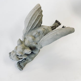 Overhead view of a Gargoyle figurine has his hands and wings upward.  He can rest vertically on your mantle or hang from the small loop that is built into him. The figurine is on a white background. House Parts home decor handmade Atlanta gargoyle grotesque whimsical fantasy mystical creature. Unique gift for fans of fantasy, dungeon, or dinosaurs. Unique Christmas gift for someone who has everything or fantasy lovers. Gothic, medieval, unique, artisan, craft, detail, specialty, a gift that no one else has,