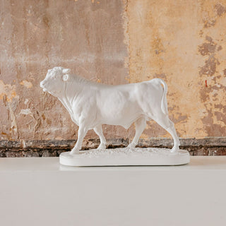 A white plaster sculpture of a bull, after Rosa Bonheur's artwork Le Taureau, placed against a backdrop with a rustic appearance.

House Parts handmade, crafted, artisan, high quality, statues, busts, and figurines.  Unique gifts for everyone. Indoor decorations, Outdoor statues and garden items. Thoughtful gift, animal lovers, rabbit lovers, instead of pet, small business, female owned family business, rabbit, bunny, dog, turtle, frog, clam shell
