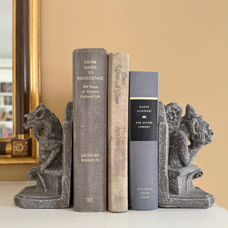 A pair of gothic gargoyles bookends sitting on a throne holding up 3 books between them.  In the background is a peach wall and a gold framed mirror

House Parts home decor handmade Atlanta gargoyle grotesque whimsical fantasy mystical creature. Unique gift for fans of fantasy, dungeon, or dinosaurs. Unique Christmas gift for someone who has everything or fantasy lovers. Gothic, medieval, unique, artisan, craft, detail, specialty, a gift that no one else has, special, protective
