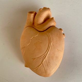 A plaster heart-shaped box with the phrase 'From the bottom of my heart' inscribed on it, in a terracotta color. Lid closed

House Parts handmade, crafted, artisan, high quality, statues, busts, and garden and animal figurines.  Unique gifts for everyone. Indoor decorations, Outdoor statues and garden items. Fantasy, whimsical, thoughtful gifts, original gift idea, shop small business, plaster, concrete, Clam shell, Gargoyles, Alice in Wonderland, animal lover gifts, pet memorial