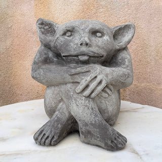 The gargoyle is sitting on top of a marble table with a peach wall in the background. House Parts home decor handmade Atlanta gargoyle grotesque whimsical fantasy mystical creature. Unique gift for fans of fantasy, dungeon, or dinosaurs. Unique Christmas gift for someone who has everything or fantasy lovers. Gothic, medieval, unique, artisan, craft, detail, specialty, a gift that no one else has, special, protective, female owned business, family small business, odd, quirky gifts