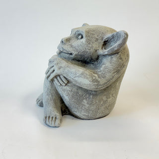 side view of a sitting cement gargoyle statue with bat-like features and his tongue sticking out on a white background. House Parts home decor handmade Atlanta gargoyle grotesque whimsical fantasy mystical creature. Unique gift for fans of fantasy, dungeon, or dinosaurs. Unique Christmas gift for someone who has everything. Gothic, medieval, unique, artisan, craft, detail, specialty, a gift that no one else has, special, protective, female owned business, family small business, local, odd, quirky gifts