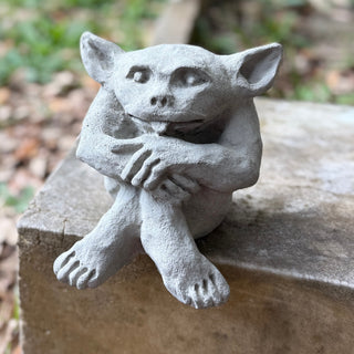 All the naughty in a smaller package. He is sitting on a wooden box outdoors.

House Parts home decor handmade Atlanta gargoyle grotesque whimsical fantasy mystical creature. Unique gift for fans of fantasy, dungeon, or dinosaurs. Unique Christmas gift for someone who has everything. Gothic, medieval, unique, artisan, craft, detail, specialty, a gift that no one else has, special, protective, female owned business, family small business, local, odd, quirky gifts