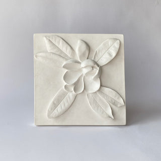 A white plaster cast of a Magnolia bud with leaf details, designed as wall art for home decor.

House Parts handmade, crafted, artisan, high quality, statues, busts, and garden and animal figurines.  Unique gifts for everyone. Indoor decorations, Outdoor statues and garden items. Fantasy, whimsical, thoughtful gifts, original gift idea, shop small business, plaster, concrete, Clam shell, Gargoyles, Alice in Wonderland, animal lover gifts, pet memorial