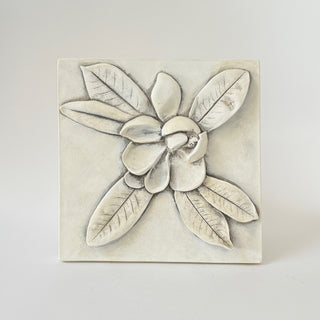 A plaster cast of a Magnolia bud, in fossil finish, with leaf details, designed as wall art for home decor. The plaque is set against a white background

House Parts handmade, crafted, artisan, high quality, statues, busts, and garden and animal figurines.  Unique gifts for everyone. Indoor decorations, Outdoor statues and garden items. Fantasy, whimsical, original gift idea, shop small business, plaster, concrete, Clam shell, Gargoyles, Alice in Wonderland, animal lover gifts, pet memorial