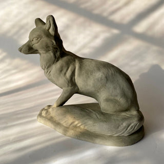 Side view view of a Sculpture of a proud valiant fox sitting up with ears raised.  His tail is resting on the base next to him. He has been photographed on a white background

House Parts handmade, crafted, artisan, high quality, statues, busts, and figurines.  Unique gifts for everyone. Indoor decorations, Outdoor statues and garden items. Thoughtful gift, animal lovers, rabbit lovers, instead of pet, small business, female owned family business, rabbit, bunny, dog, turtle, frog, clam shell