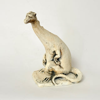 White stone sculpture of a dinosaur on a light gray background. House Parts home decor handmade Atlanta gargoyle grotesque whimsical fantasy mystical creature. Unique gift for fans of fantasy, dungeon, or dinosaurs. Unique Christmas gift for someone who has everything or fantasy lovers. Gothic, medieval, unique, artisan, craft, detail, specialty, a gift that no one else has, special, protective